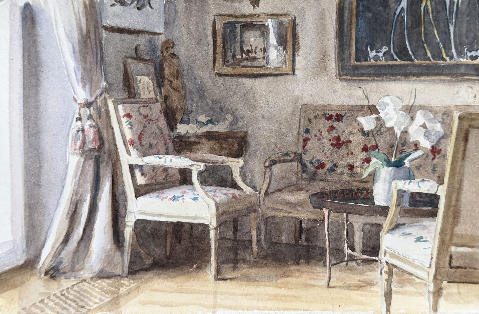 Watercolour of a salon: two flowered armchairs and a settee around a small table with white flowers, a curtained window and pictures on a grey wall